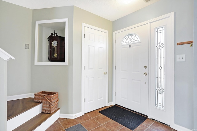 tiled entrance foyer with baseboards