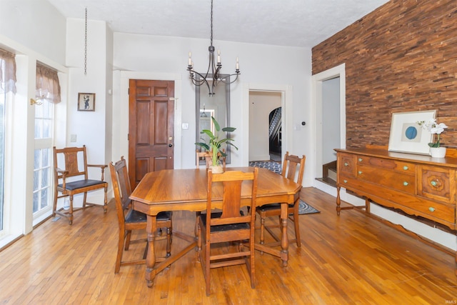 dining space featuring an inviting chandelier and light wood-style flooring