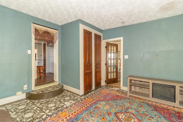 interior space featuring baseboards and a textured ceiling