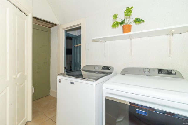 laundry area featuring light tile patterned floors, laundry area, and independent washer and dryer