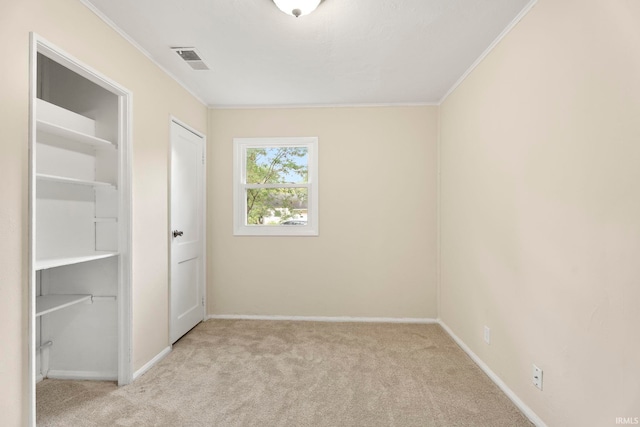 unfurnished bedroom featuring carpet floors, baseboards, visible vents, and ornamental molding