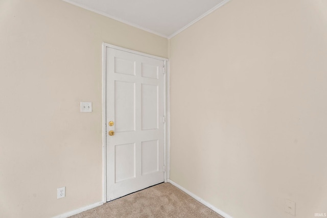 unfurnished room with light carpet, crown molding, and baseboards