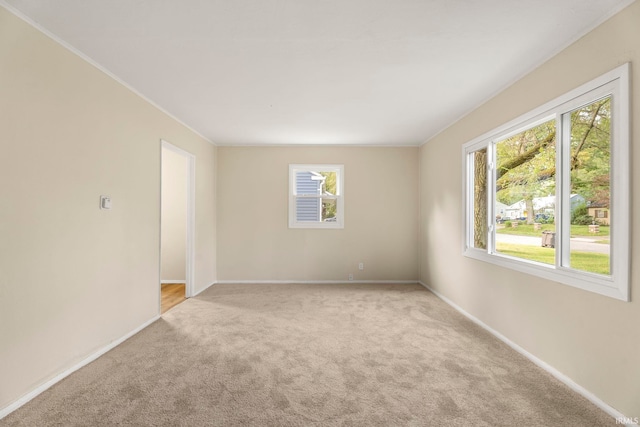 empty room with light carpet and baseboards