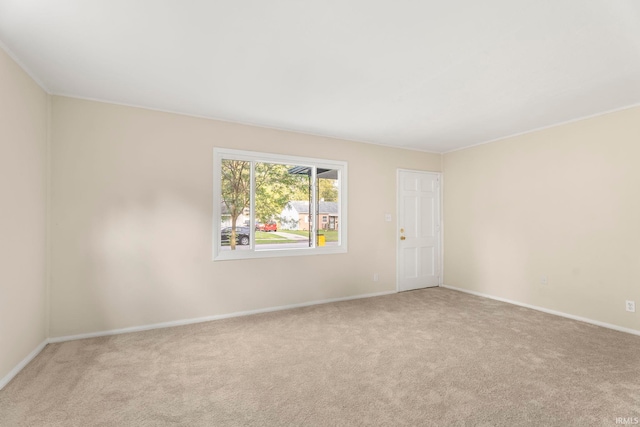 unfurnished room featuring carpet and baseboards