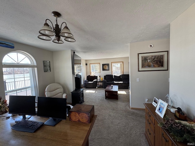 living room with carpet floors, baseboards, and an inviting chandelier