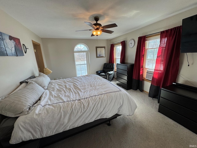 bedroom with carpet floors, cooling unit, and a ceiling fan