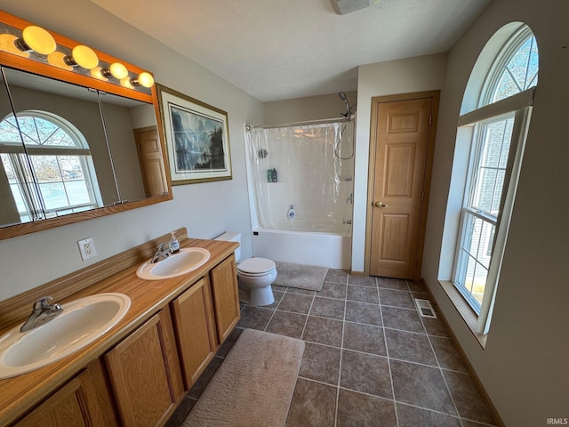 bathroom featuring tile patterned flooring, visible vents, a sink, and double vanity