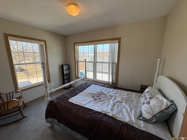 carpeted bedroom with baseboards and a textured ceiling