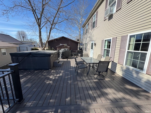 deck with a hot tub, outdoor dining area, and cooling unit