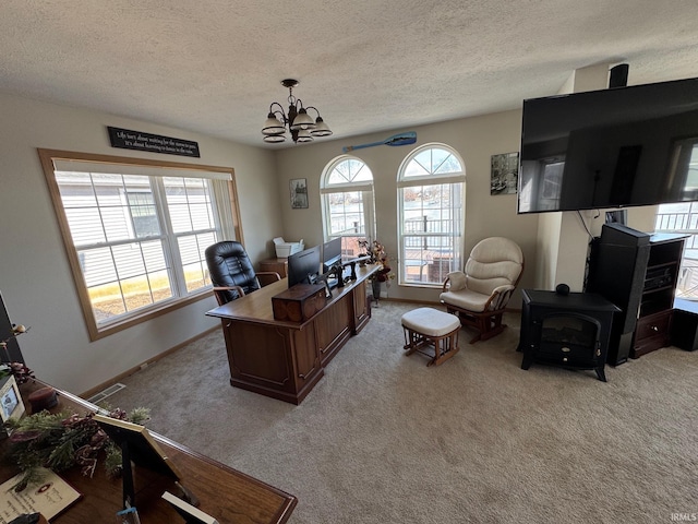 home office with visible vents, a chandelier, a wealth of natural light, and light colored carpet