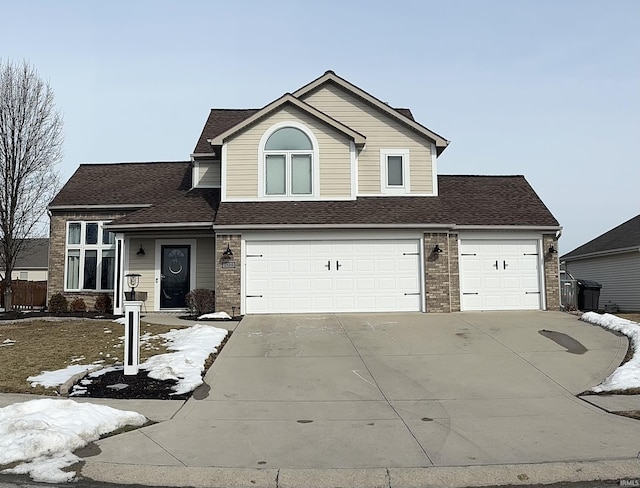 view of front of property featuring driveway, roof with shingles, and brick siding