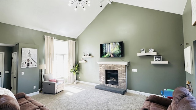 living area featuring baseboards, carpet flooring, a fireplace, high vaulted ceiling, and track lighting