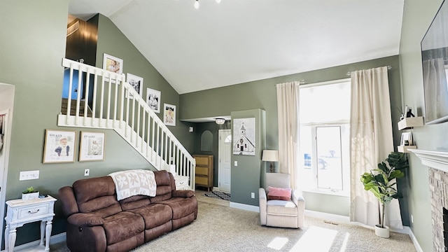 carpeted living area with arched walkways, a fireplace, vaulted ceiling, baseboards, and stairs