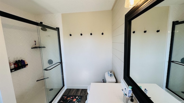 bathroom with a stall shower, vanity, and toilet