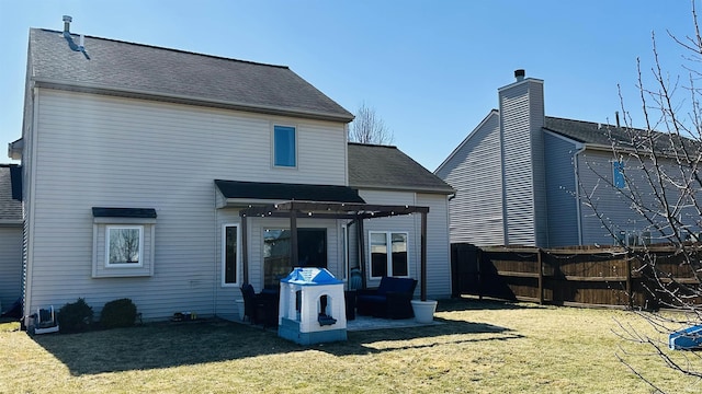 rear view of property featuring a shingled roof, fence, a lawn, a pergola, and a patio