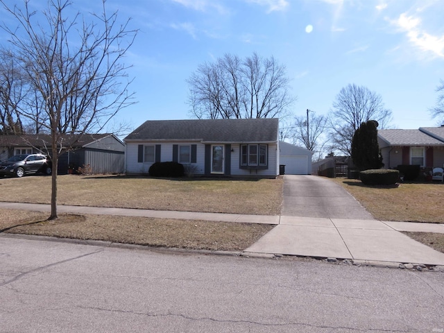 ranch-style house with a garage, an outbuilding, and a front yard