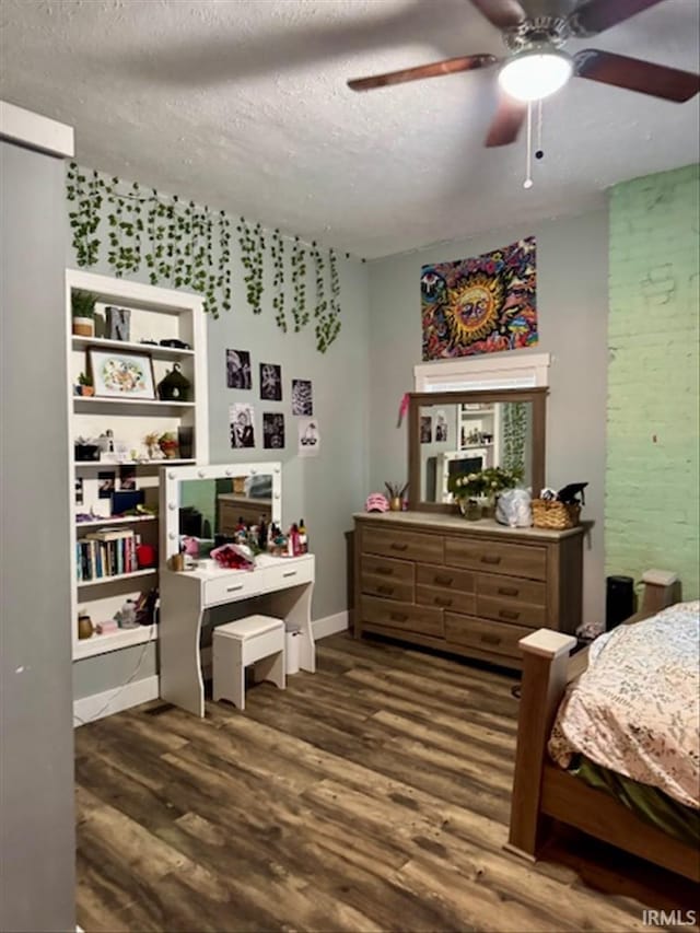 bedroom with baseboards, a textured ceiling, a ceiling fan, and wood finished floors