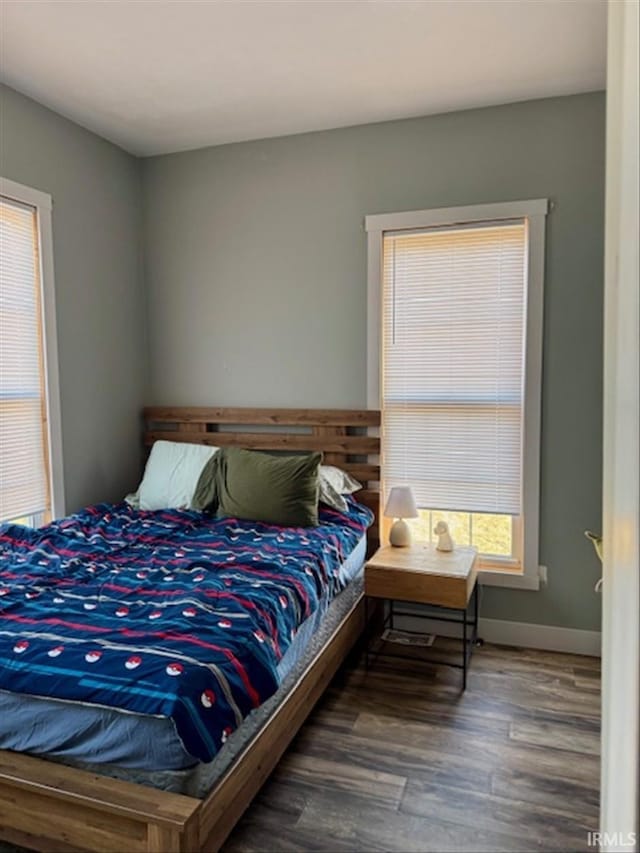 bedroom featuring baseboards and wood finished floors