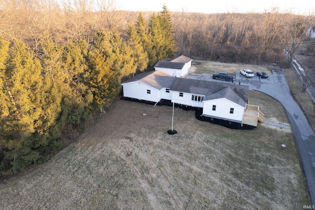 drone / aerial view with a wooded view