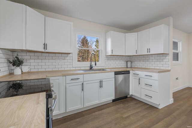 kitchen featuring stainless steel appliances, dark wood-style flooring, a sink, wood counters, and white cabinets