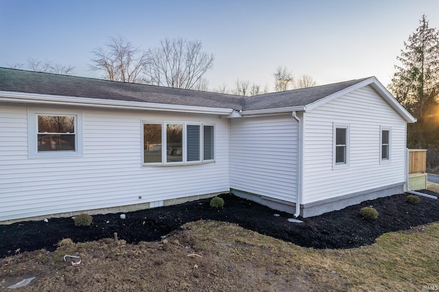 view of property exterior featuring roof with shingles