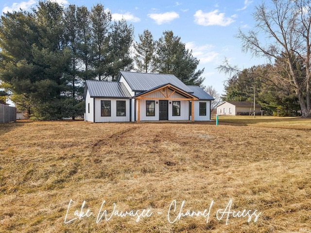 modern inspired farmhouse with a front yard and metal roof