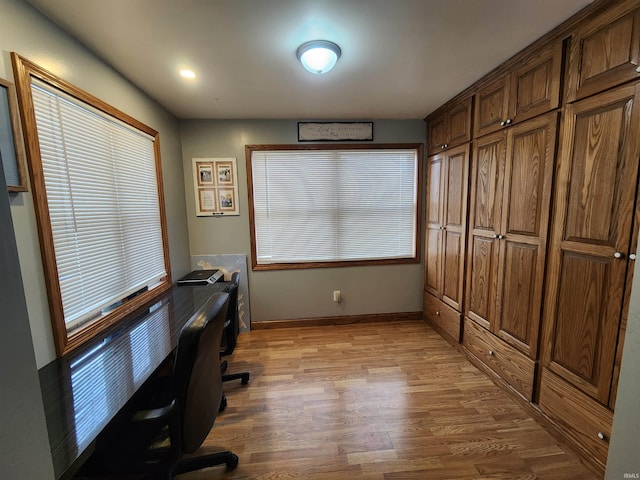 office area featuring plenty of natural light, wood finished floors, and baseboards