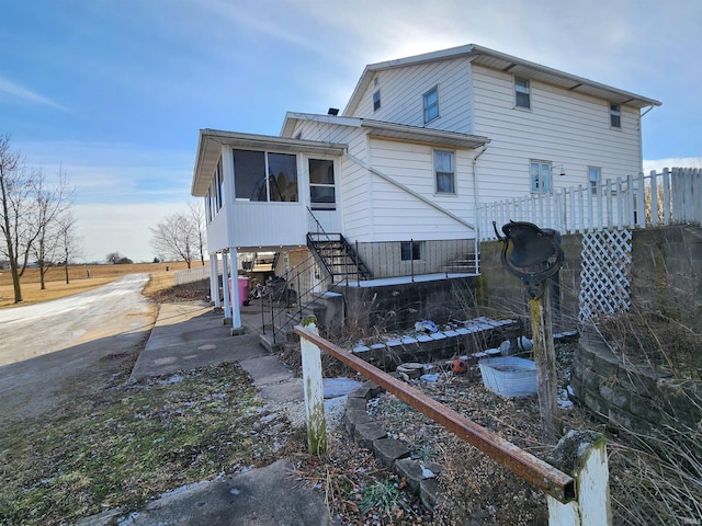 back of house with a sunroom