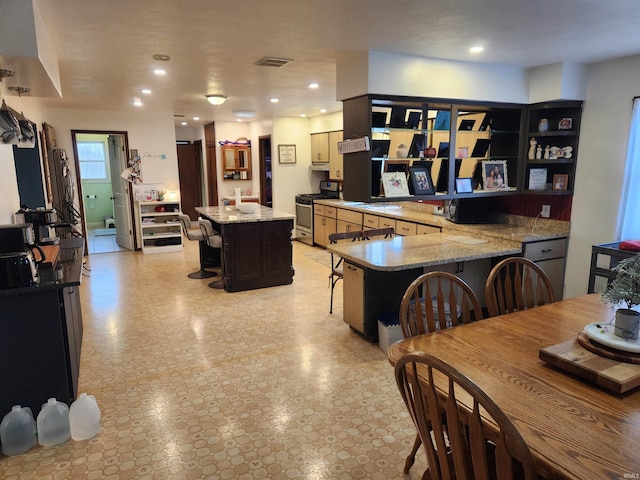 dining area featuring light floors, visible vents, and recessed lighting