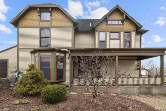 victorian home with a porch and central air condition unit