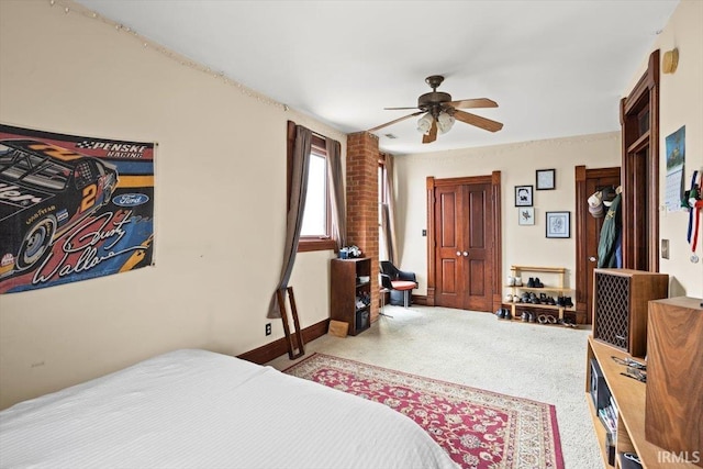 carpeted bedroom featuring ceiling fan and baseboards