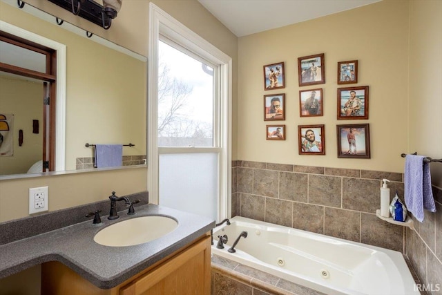 bathroom with a jetted tub and vanity