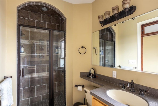 bathroom with a shower stall and vanity