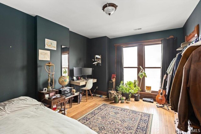 bedroom featuring visible vents and hardwood / wood-style flooring