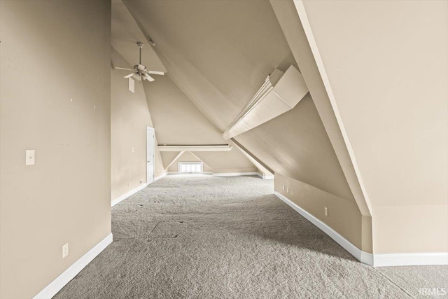 bonus room featuring lofted ceiling, carpet flooring, and baseboards