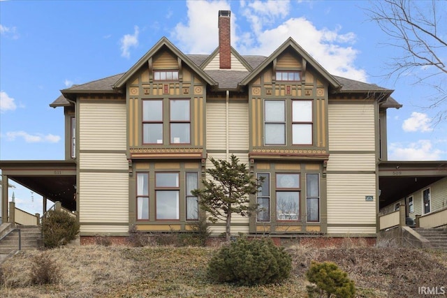 back of house featuring a chimney