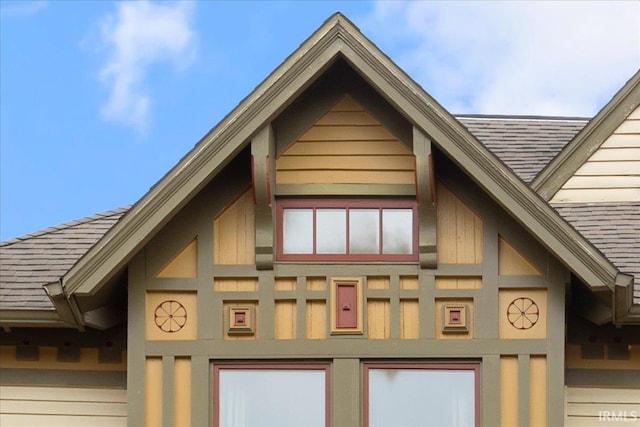 view of property exterior with roof with shingles