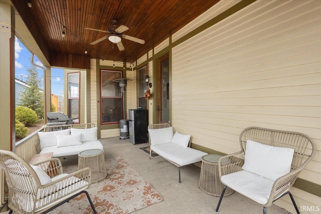 sunroom featuring wooden ceiling and ceiling fan