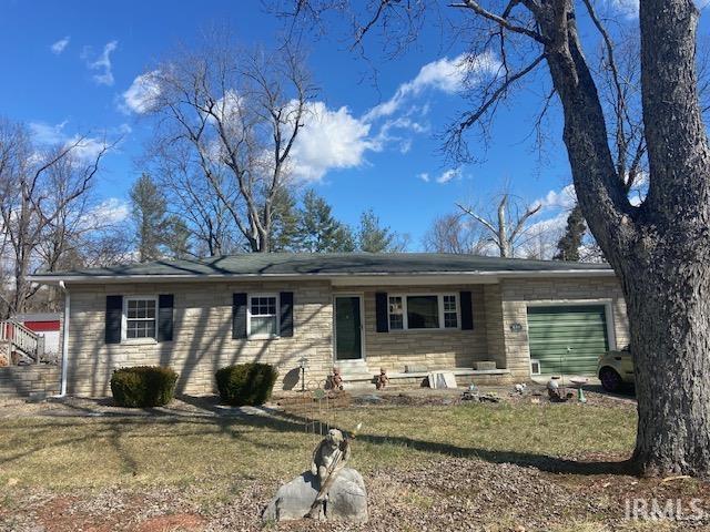 ranch-style home with entry steps and an attached garage