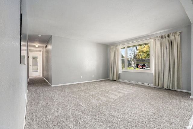 unfurnished room with carpet and baseboards