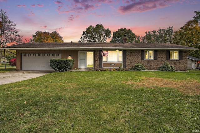 single story home with driveway, a chimney, an attached garage, a front lawn, and brick siding