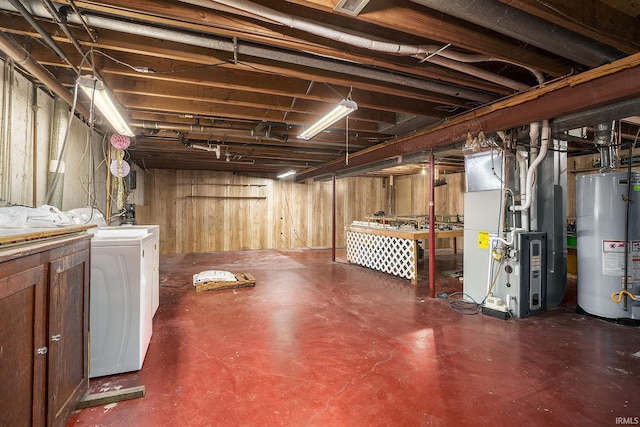 unfinished below grade area with heating unit, water heater, and washer and dryer