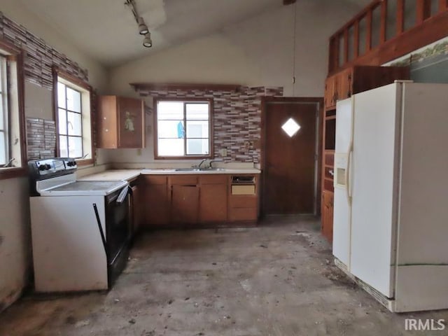 kitchen with lofted ceiling, light countertops, electric range oven, a sink, and white fridge with ice dispenser