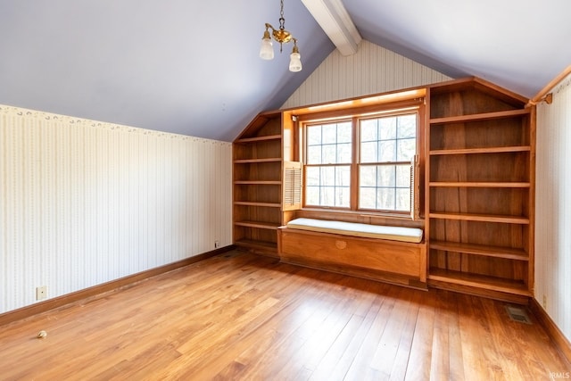 additional living space with vaulted ceiling with beams, visible vents, baseboards, light wood finished floors, and wallpapered walls