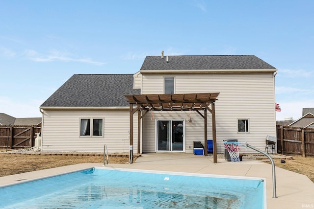 back of house with a fenced in pool, a fenced backyard, a patio, and a pergola