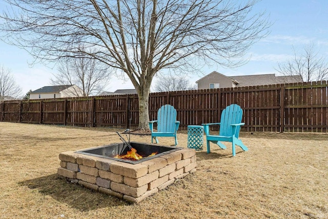 view of yard featuring an outdoor fire pit and a fenced backyard