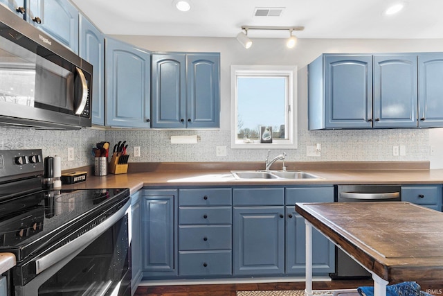 kitchen featuring blue cabinets and stainless steel appliances