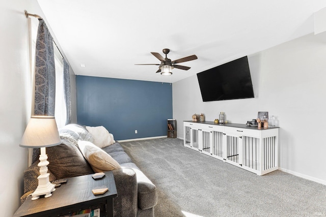 living room with a ceiling fan, carpet flooring, and baseboards