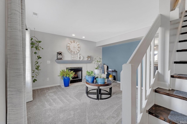 sitting room with carpet floors, baseboards, a fireplace, and stairway