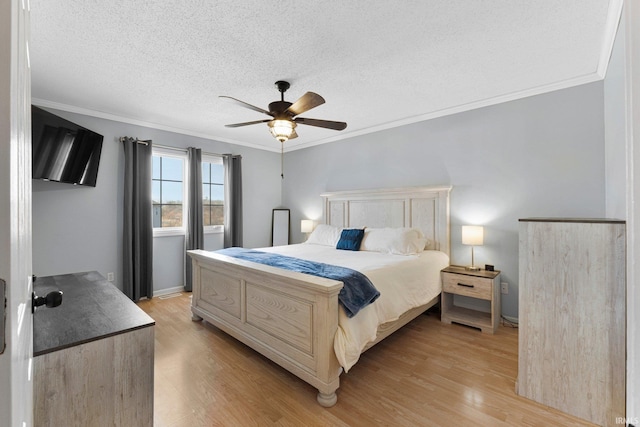 bedroom with ceiling fan, a textured ceiling, baseboards, light wood-style floors, and crown molding